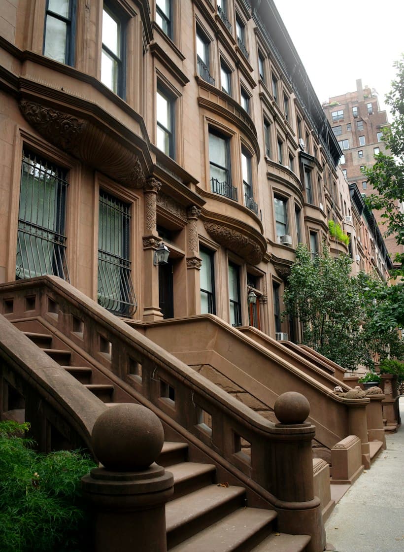 A row of brownstone houses with stone front steps